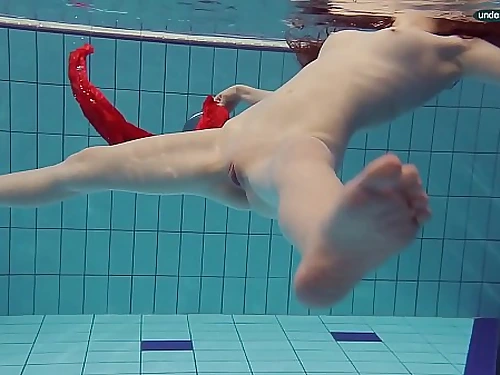 Red Clad teen swimming with her eyes opened